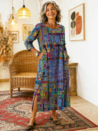 Older woman wears a blue multicolour patchwork-print midi dress with three-quarter sleeves, styled with leopard-print flats