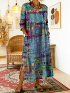 Side angle showing the loose, flowing cut of the patchwork midi dress and the leg-baring side slit