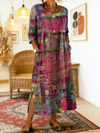 Styled full-body shot of the patchwork midi dress in a boho-inspired living room setting with wicker furniture