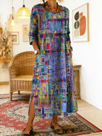 Front view of the blue patchwork midi dress showing the round neckline, crochet-trim waist detail and side slit