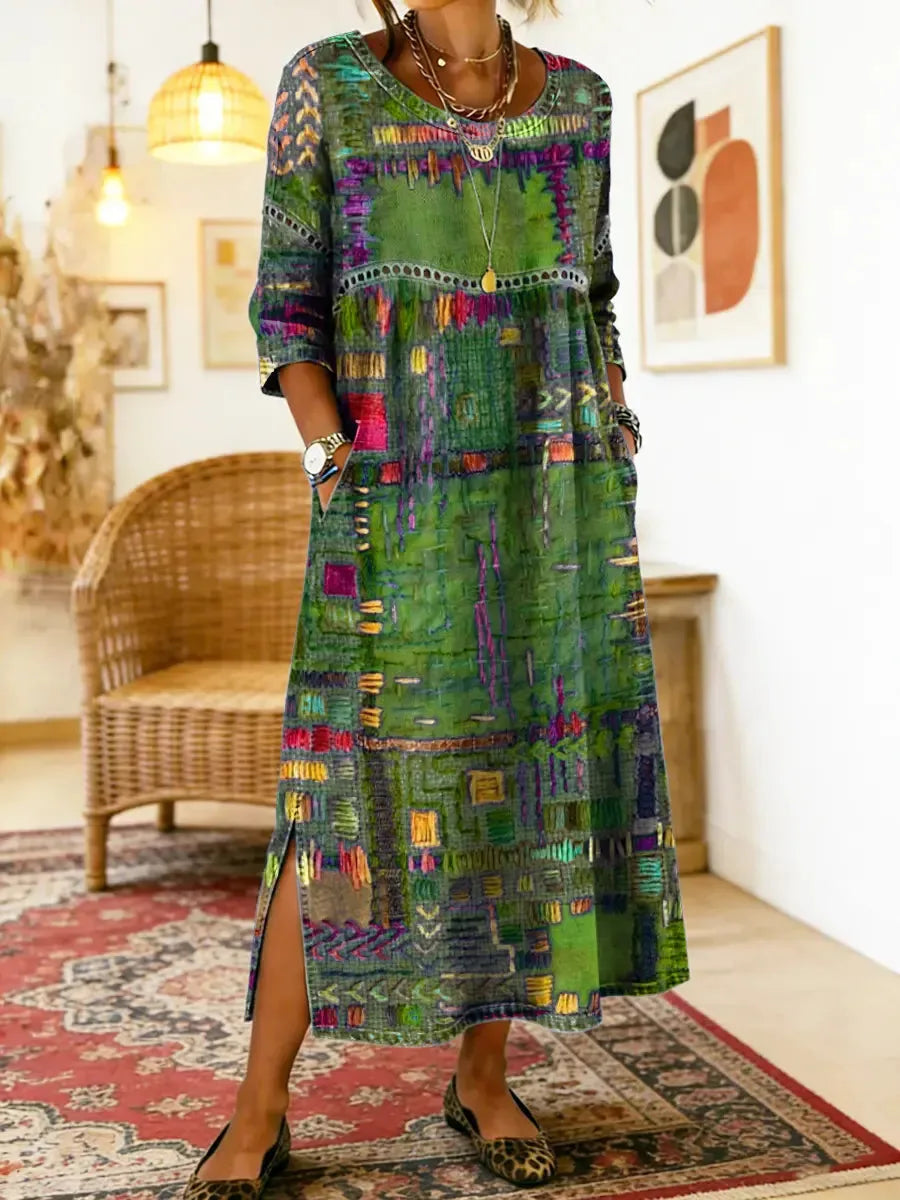 Green patchwork-print midi dress shown from the front, highlighting the relaxed A-line silhouette and long sleeves