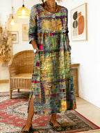 Golden-yellow patchwork-print midi dress with crochet trim, worn with leopard flats on a patterned rug
