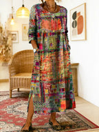 Orange and red patchwork-print dress shown from the front, highlighting the three-quarter sleeves and midi length