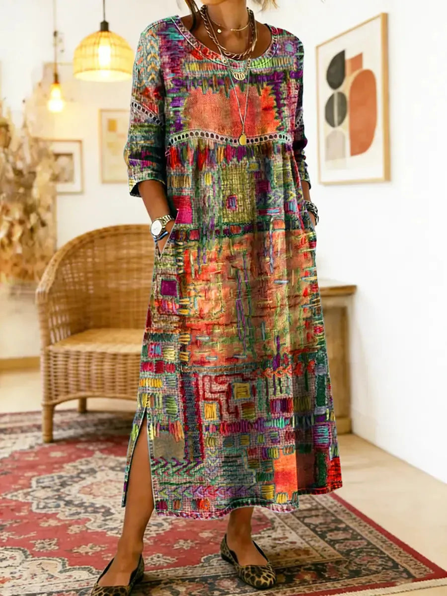 Orange and red patchwork-print dress shown from the front, highlighting the three-quarter sleeves and midi length