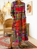 Close-up of the round neckline and crochet lace trim detail across the chest of the patchwork-print dress