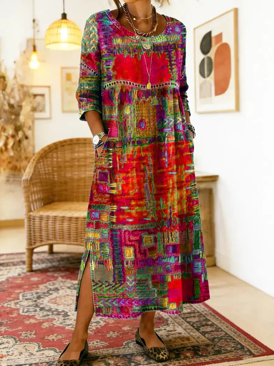 Close-up of the round neckline and crochet lace trim detail across the chest of the patchwork-print dress
