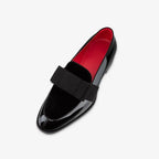 Close-up detail of the grosgrain bow and velvet panel on a formal loafer upper