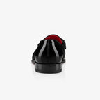 Wide shot of the loafer pair on a plain background showing the overall silhouette and glossy finish