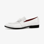 Side profile of white patent leather loafer showing bow strap and contrasting black outsole