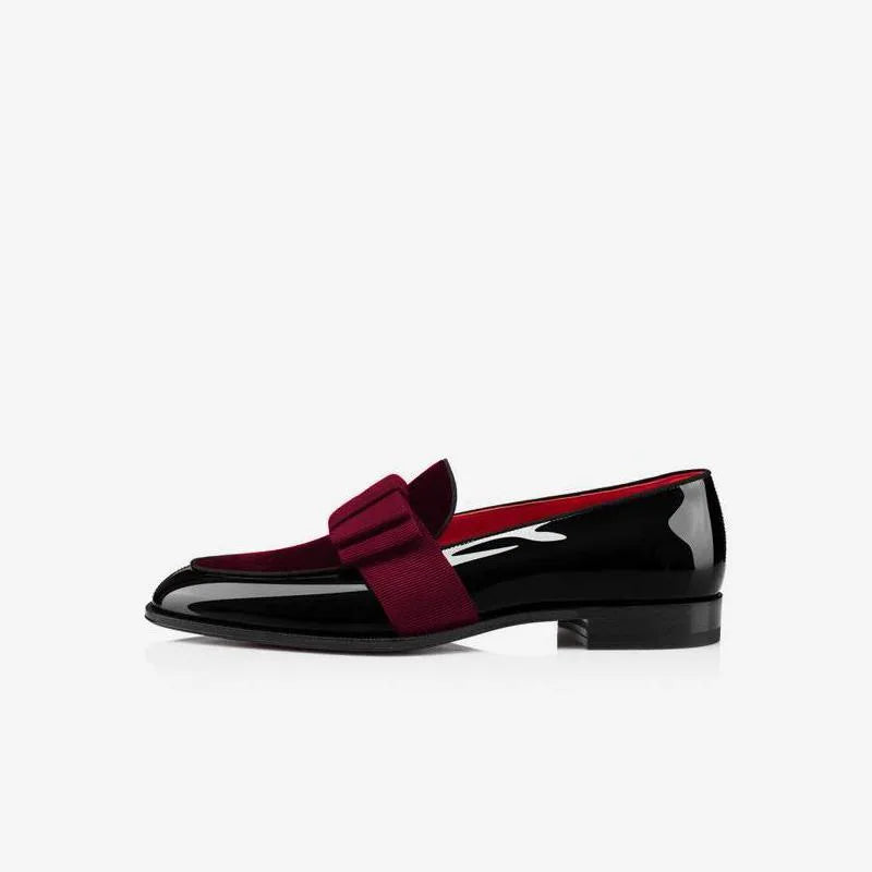 Close-up side view of white patent leather loafer with grosgrain bow on glossy upper