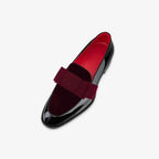 Side profile of burgundy velvet and black patent loafer showing red leather lining inside