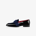 Top-down view of burgundy velvet bow loafer with black patent toe and red insole