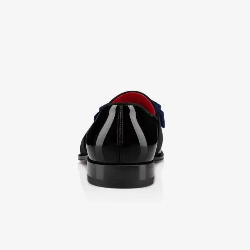 Top-down angled view of navy velvet bow loafer with black patent leather and red lining