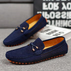 Close side view of grey suede loafer showing fine perforation pattern and tonal stitching