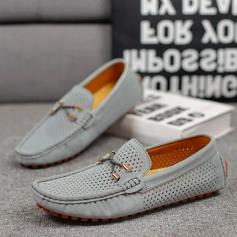 Navy suede loafer photographed from a high angle showing the moccasin-style toe and heel cup