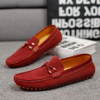 Wine red suede loafer close-up showing mustard interior and orange pebble sole detail