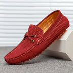 Wine red suede perforated loafer with contrast stitching and orange sole, shown in side profile