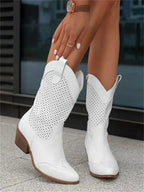 Close-up side view of white perforated leather mid-calf western boots with stacked block heel and pointed toe