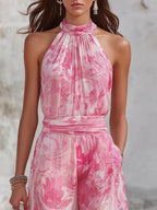 Close-up of the halter neckline and gathered bodice in a pink and white marble print, showing the lightweight woven fabric