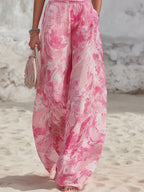 Close-up of the wide-leg trousers with the pink marble print and a hand resting in the side pocket