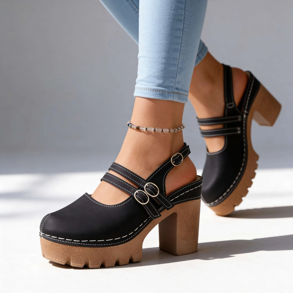 Front view of beige platform clog heels with double buckle straps and rounded almond toe