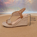 Front view of navy blue woven wedge sandals with open toe and gold ankle chain detail