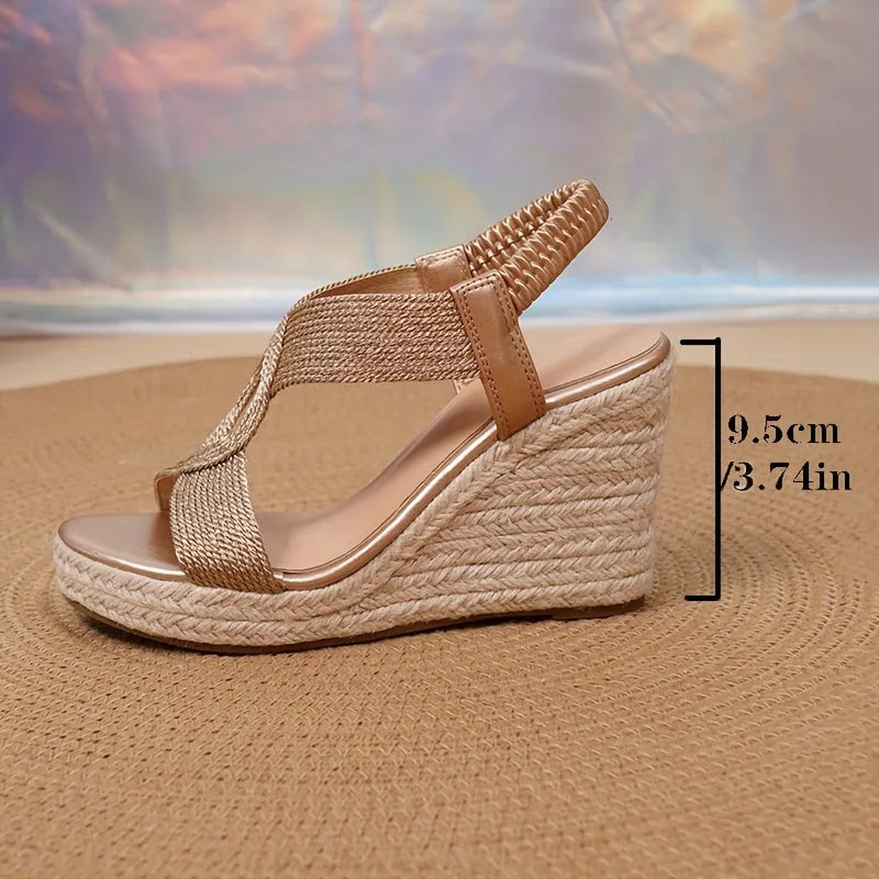 Front view of navy blue woven wedge sandals with open toe and gold ankle chain detail