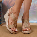 Front view of navy blue criss-cross strap wedge sandals with gold ankle chain on model