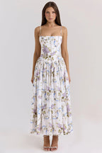 Side view of a strapless white floral corset dress with visible boning seams and a full pleated skirt