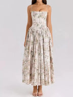 Front view of a soft pink and peach floral print corset midi dress with a gathered skirt