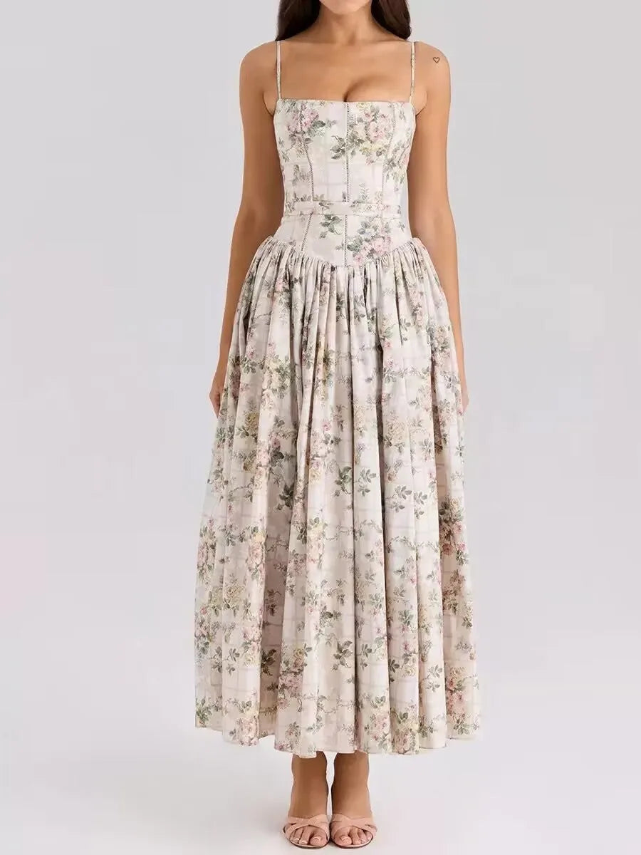 Front view of a soft pink and peach floral print corset midi dress with a gathered skirt