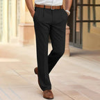 Back view of tailored black dress pants worn with a brown leather belt and classic brown shoes