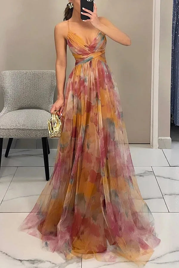 Front view of model in orange floral tulle maxi dress with spaghetti straps and wrap V-neckline