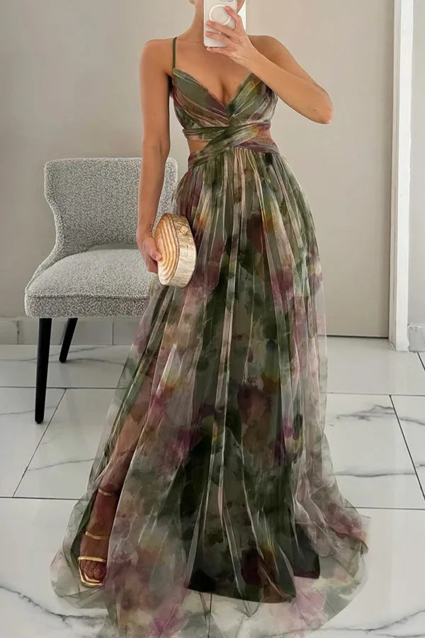 Front view of model in green floral tulle maxi dress with crossover wrap bodice and flowing skirt