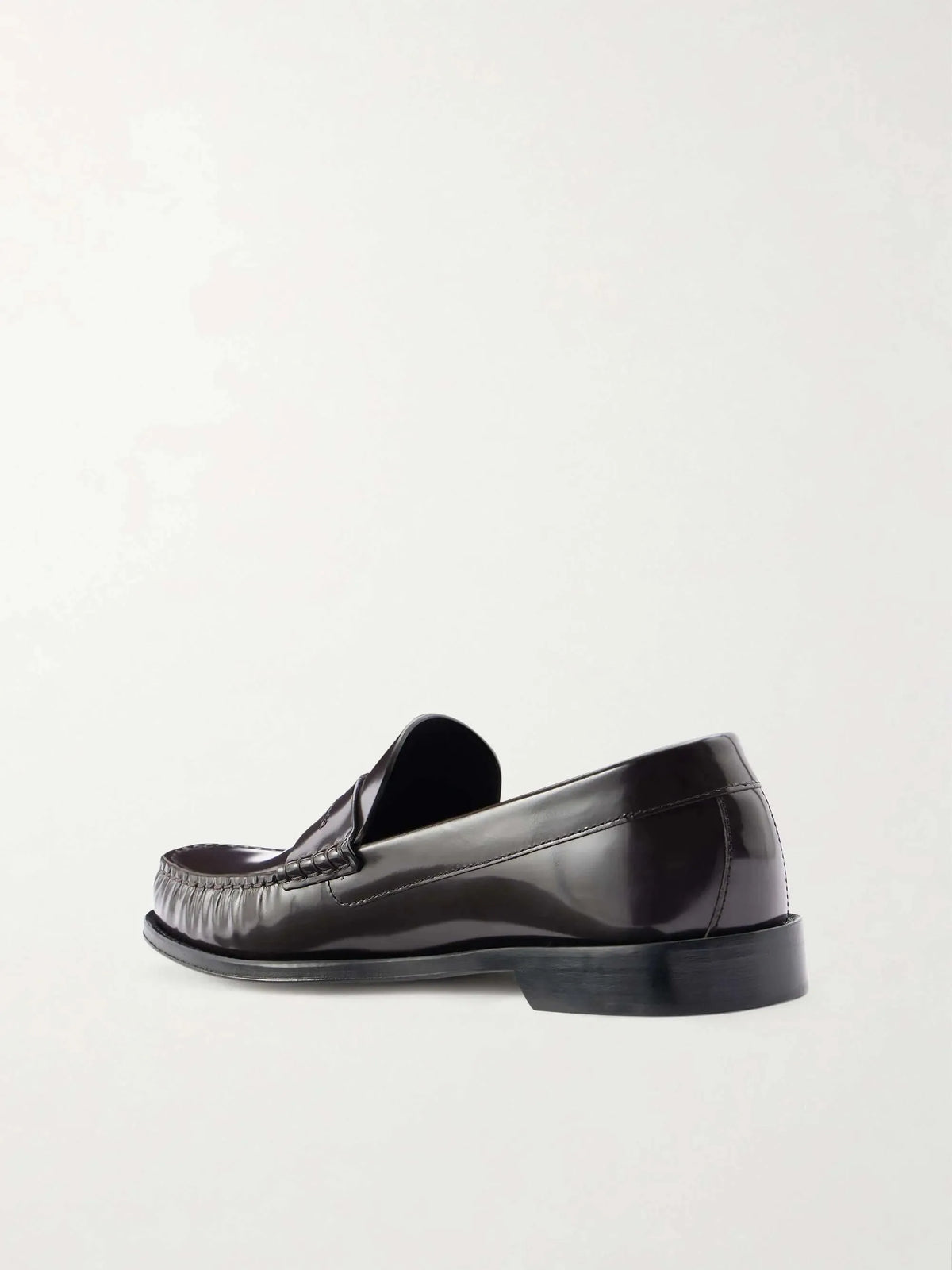 Rear side view of the brown leather loafer showing the heel counter, stacked heel and smooth leather sole trim