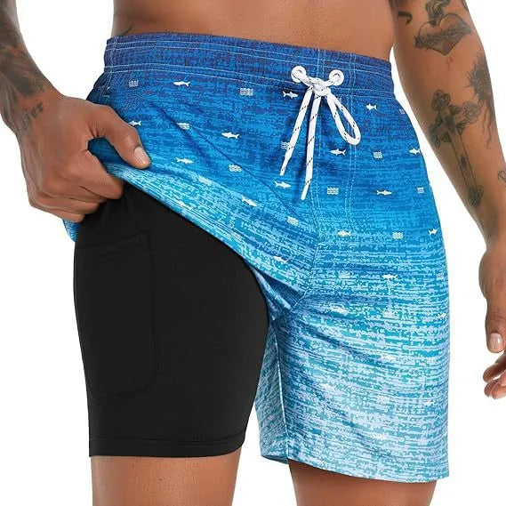 Side view of blue ombre shark-print swim shorts with black compression liner and white drawstring
