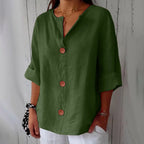 Grey blouse detail shot showing the rolled cuff sleeve and relaxed oversized fit