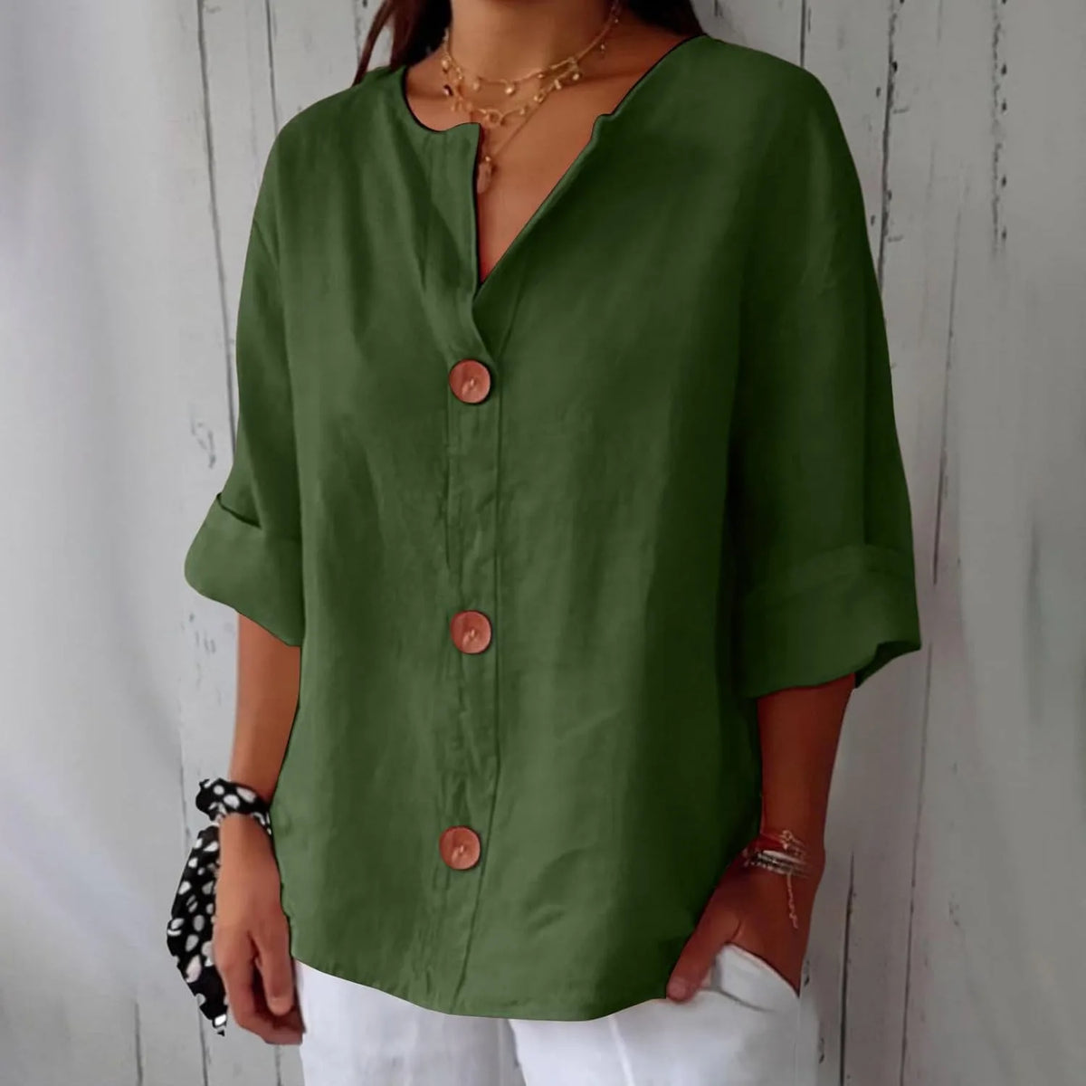 Grey blouse detail shot showing the rolled cuff sleeve and relaxed oversized fit