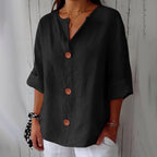 Front close-up of the orange blouse highlighting the wooden button detail and soft fabric drape