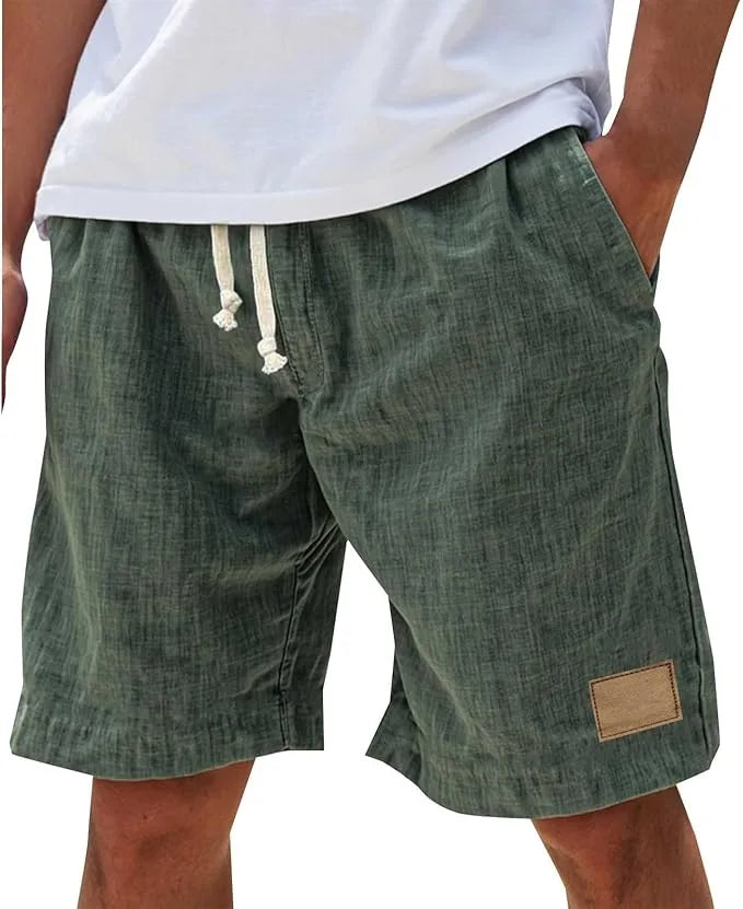 Close-up of the elastic drawstring waistband and stitched detailing on the cotton shorts