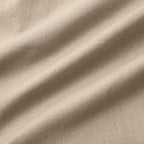 Close-up of the drawstring cord with knotted ends against the textured cotton fabric