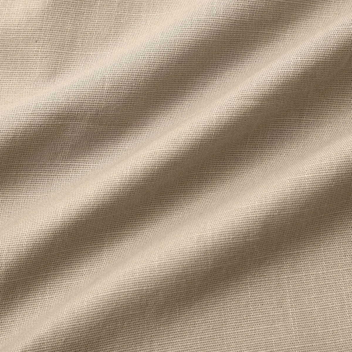 Close-up of the drawstring cord with knotted ends against the textured cotton fabric