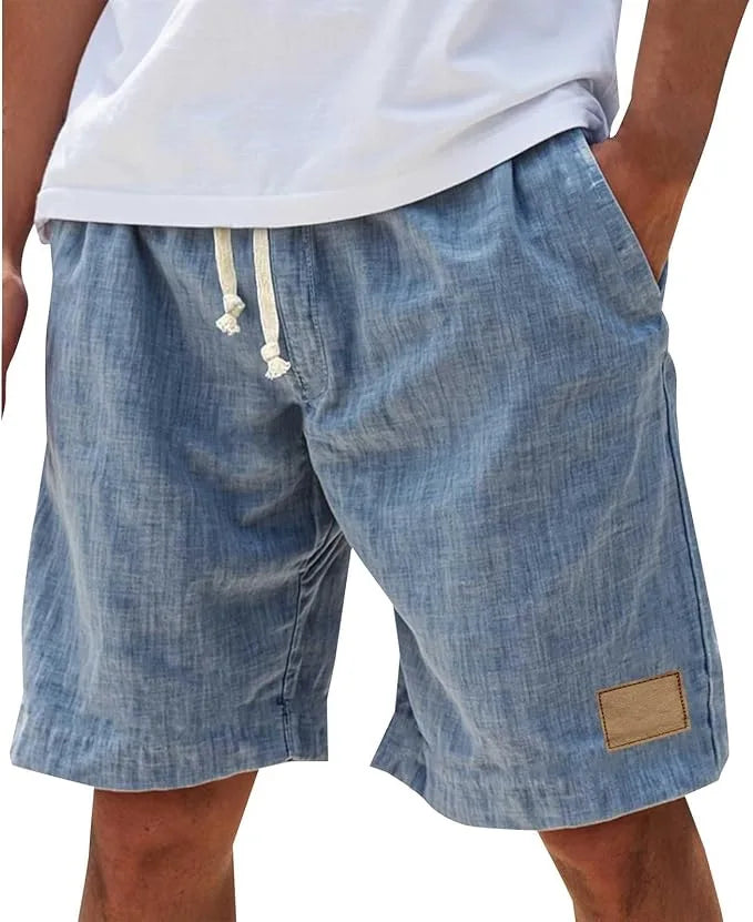 Black cotton shorts in textured weave, back view with drawstring tied and side pocket visible