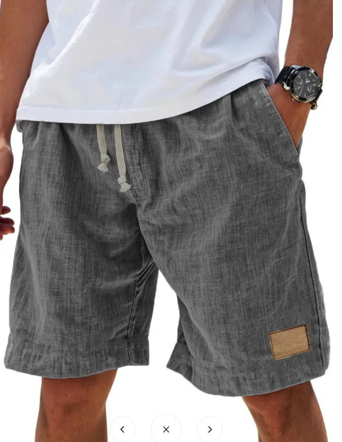 Sage green cotton shorts worn with white t-shirt, back view showing drawstring and patch detail