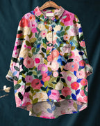 Front view of a relaxed floral linen shirt in pink, cream and green watercolour roses with a chest pocket