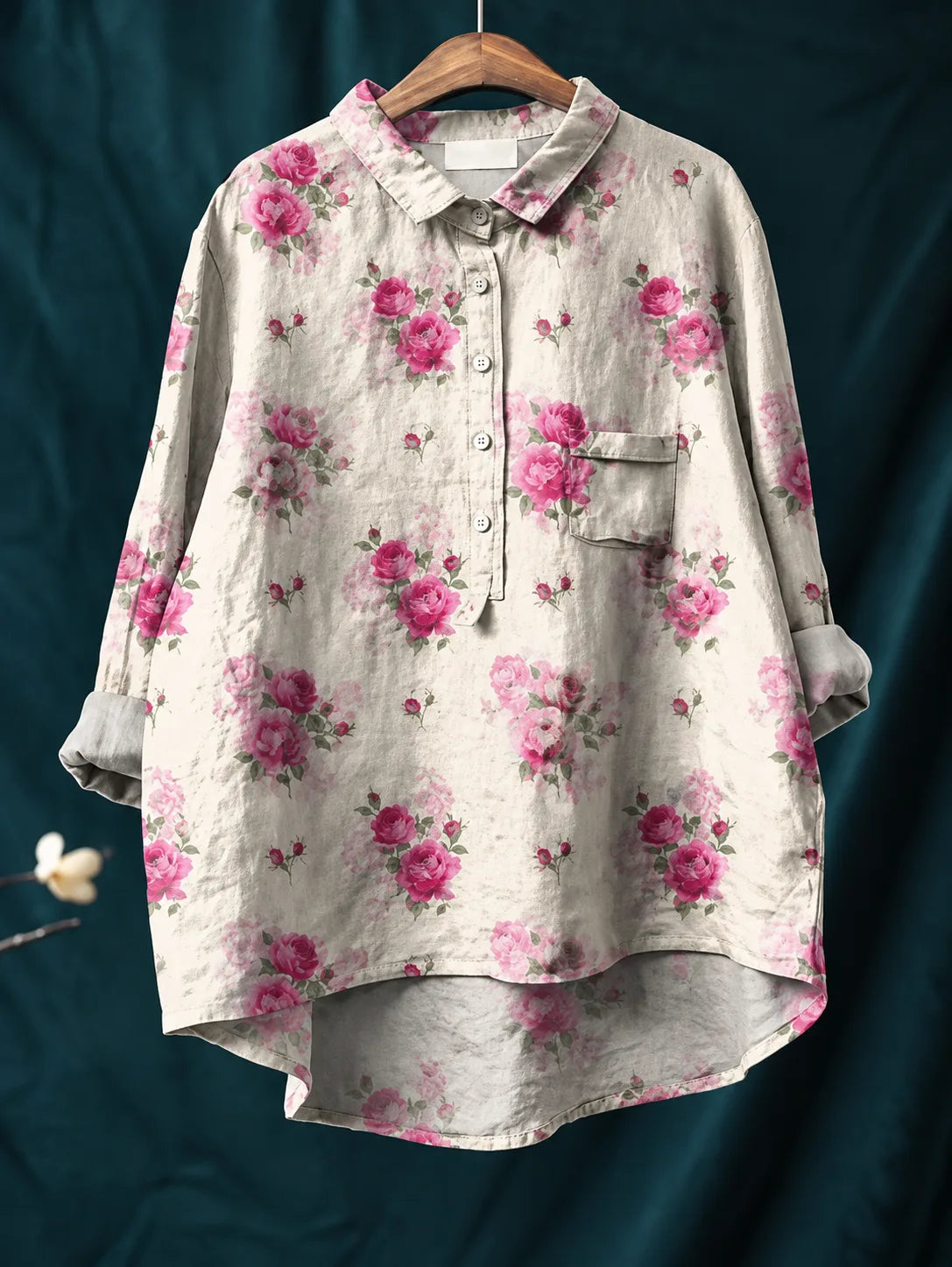 Shirt displayed on a wooden hanger showing the rolled long sleeves and patch chest pocket