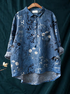 Detail shot of the button-down placket with white buttons against the floral linen fabric