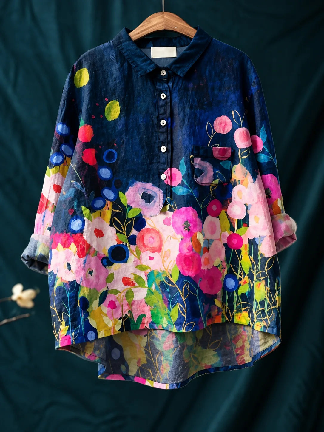 Back view showing the longer curved hem and the flow of the floral print across the fabric