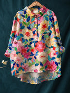 Floral shirt with pink and red blooms set against teal leaf outlines and a button placket