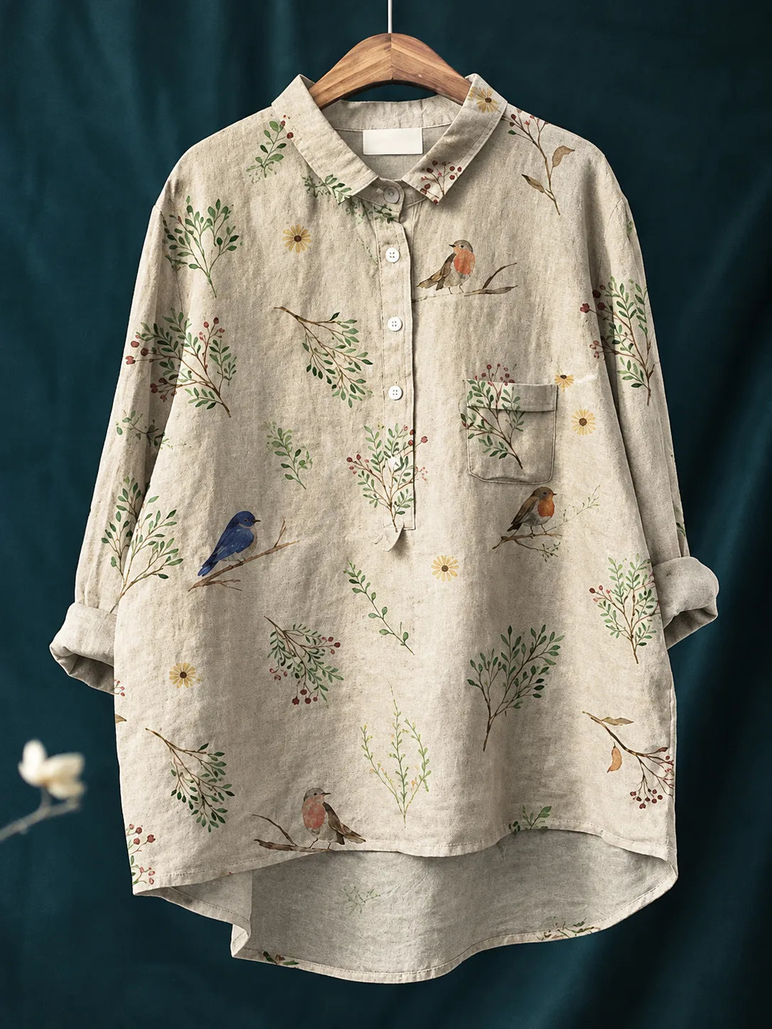 Linen shirt in natural oatmeal tone printed with small birds perched among green branches and florets